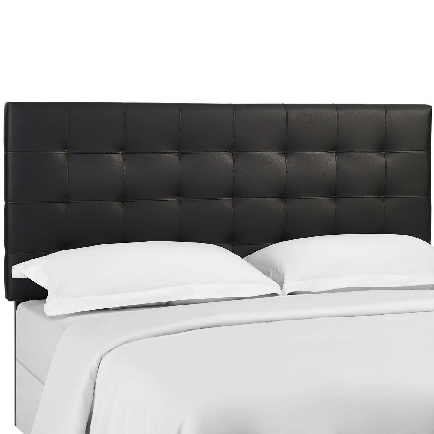 Black tufted faux-leather headboard with square stitching on a white platform bed.