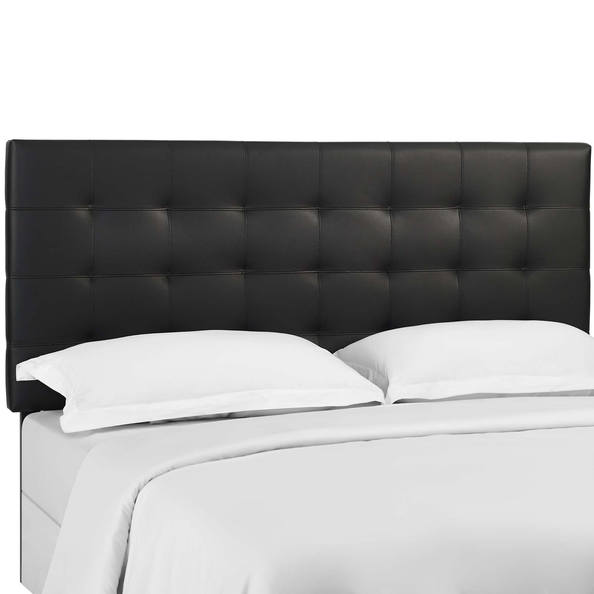 Black tufted faux-leather headboard with square stitching on a white platform bed.