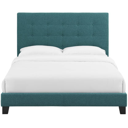 Blue fabric upholstered bed with tufted headboard and low footboard, white bedding.