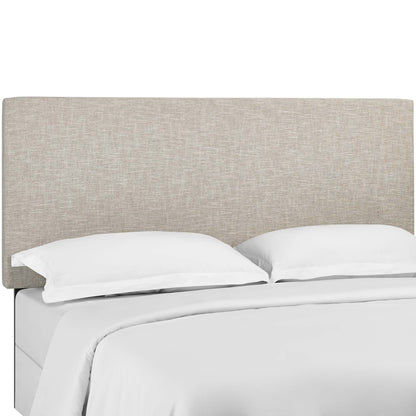 Beige fabric upholstered headboard on a bed with white sheets and pillows.