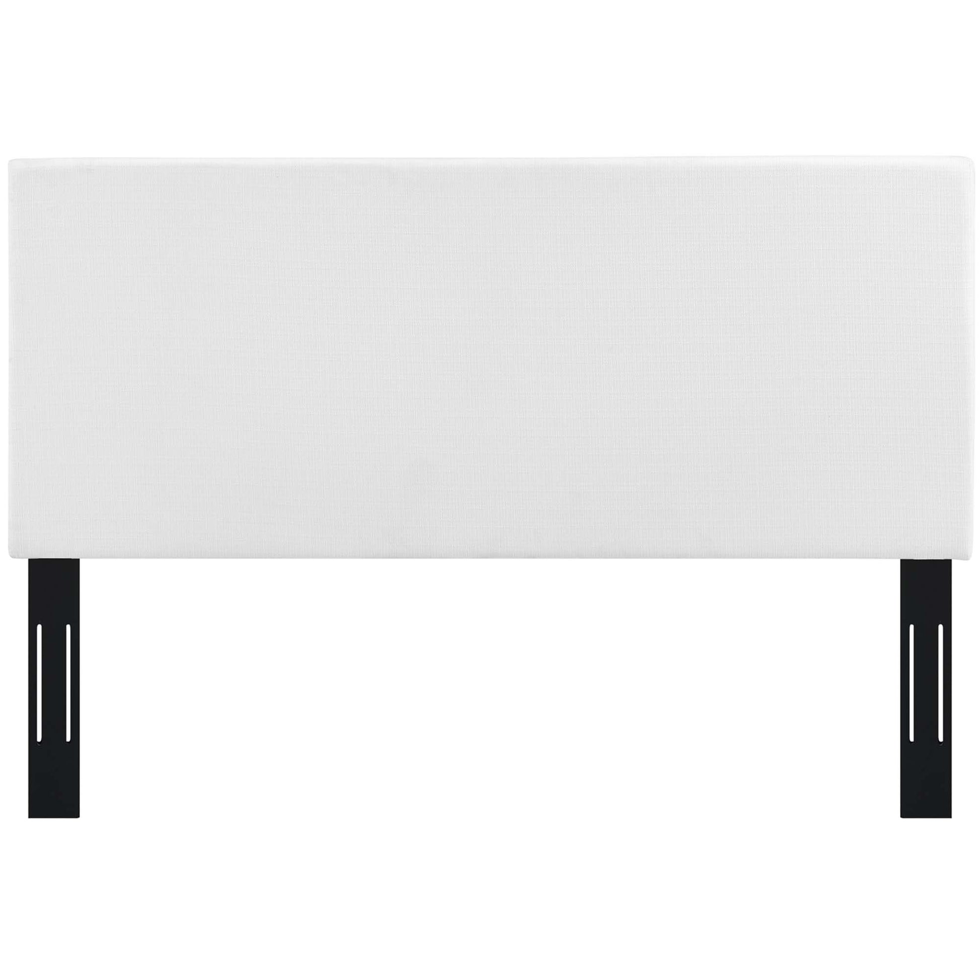 White rectangular upholstered headboard in linen fabric with vertical seams.