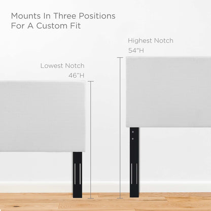 White upholstered headboard panels on black metal adjustable legs with 46in and 54in height notches for a custom fit.