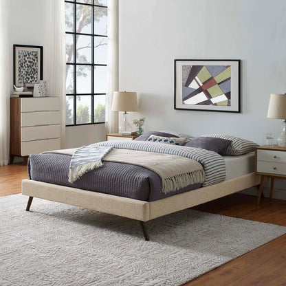 Cream upholstered fabric full bed frame with round splayed legs, beige bedding and striped pillows in a mid-century modern bedroom.
