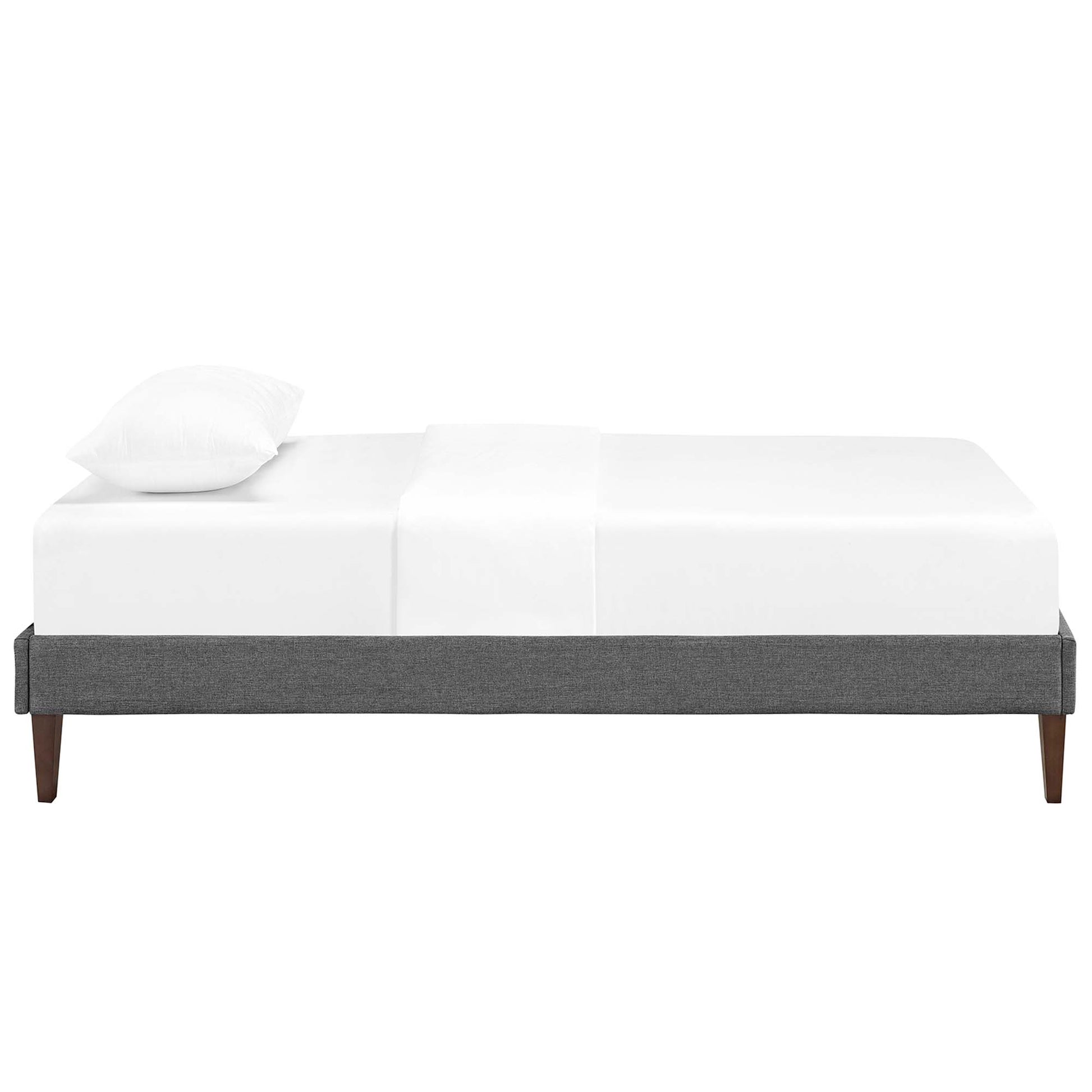 Gray upholstered platform bed frame with tapered wooden legs and white bedding.