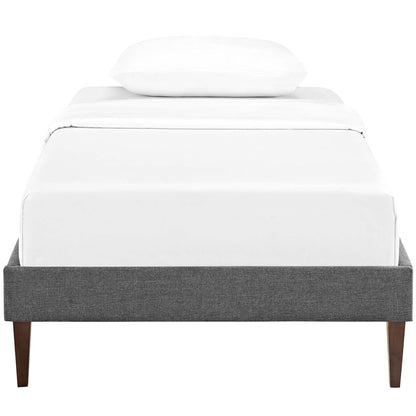 Modern gray fabric twin bed frame with white linens, a single pillow and squared tapered legs.
