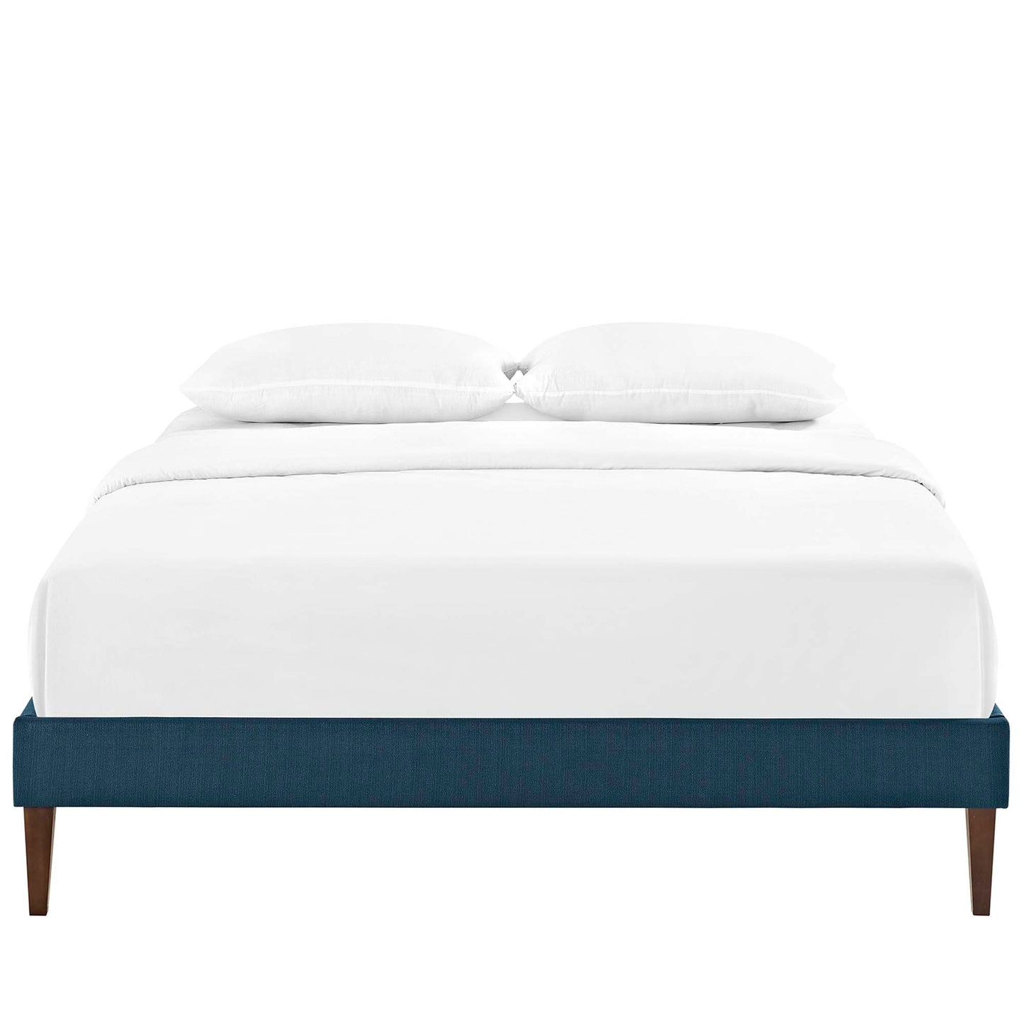 Low-profile navy blue upholstered platform bed with white bedding and two pillows, wooden tapered legs.