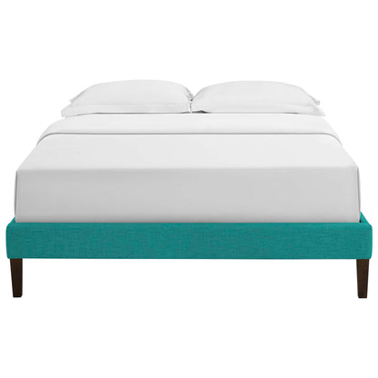 Teal fabric full-size bed frame with white bedding and two pillows, squared tapered legs.