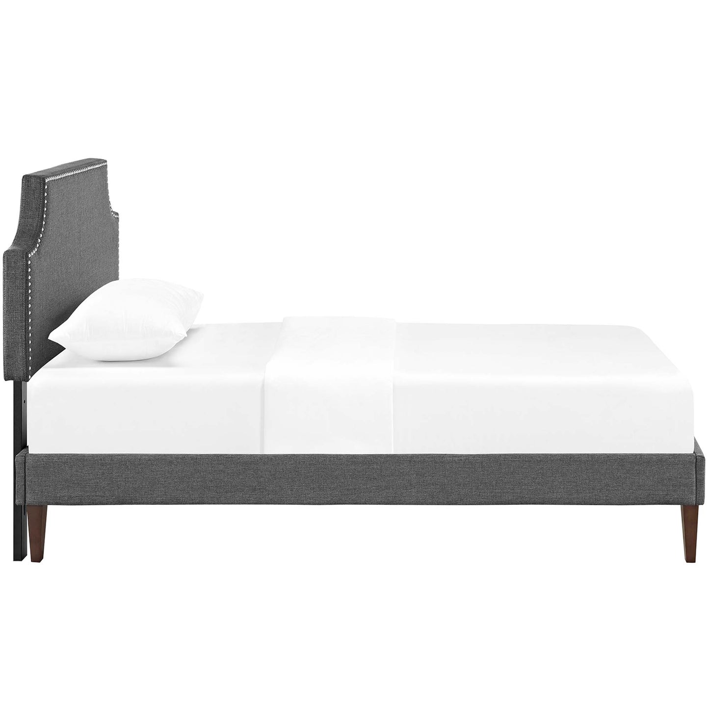 Grey fabric twin platform bed with squared tapered legs and white bedding.