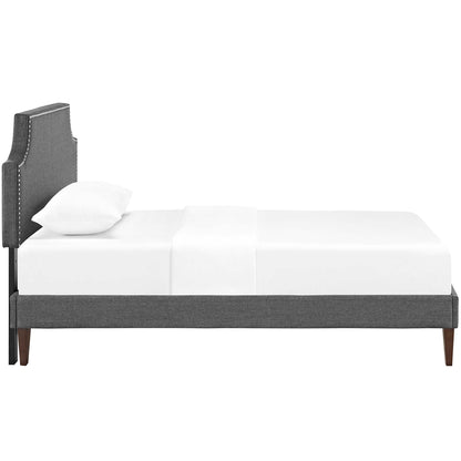 Grey fabric twin platform bed with squared tapered legs and white bedding.