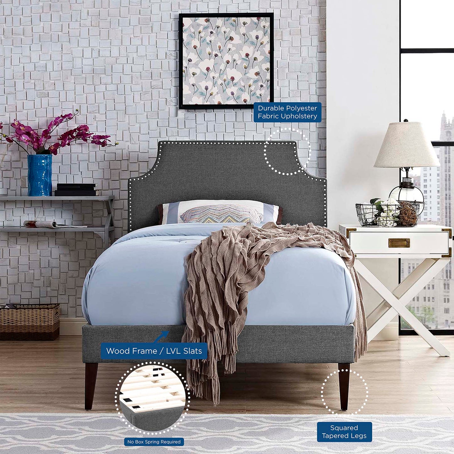 Grey fabric twin platform bed with squared tapered legs and LVL slats; blue bedding and cozy throw