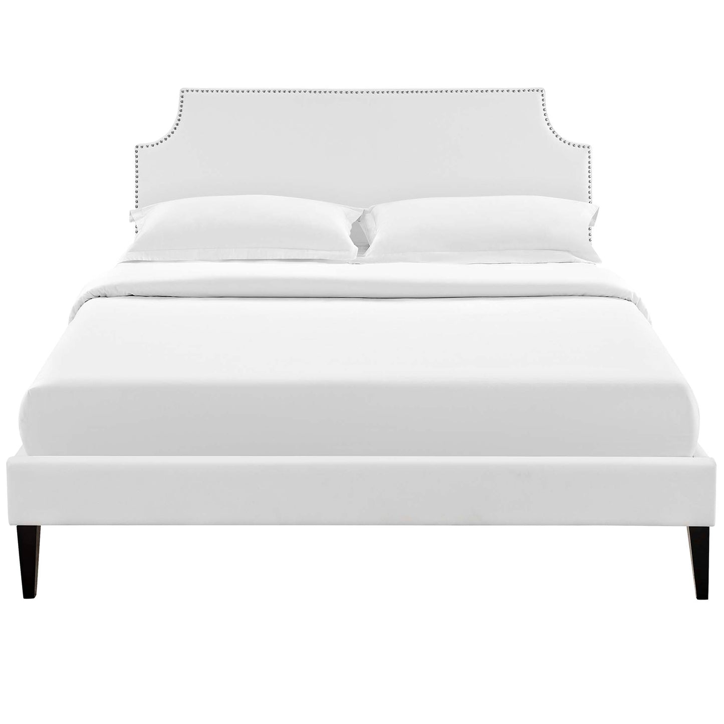 White upholstered bed with curved studded headboard, low footboard, and dark tapered legs.