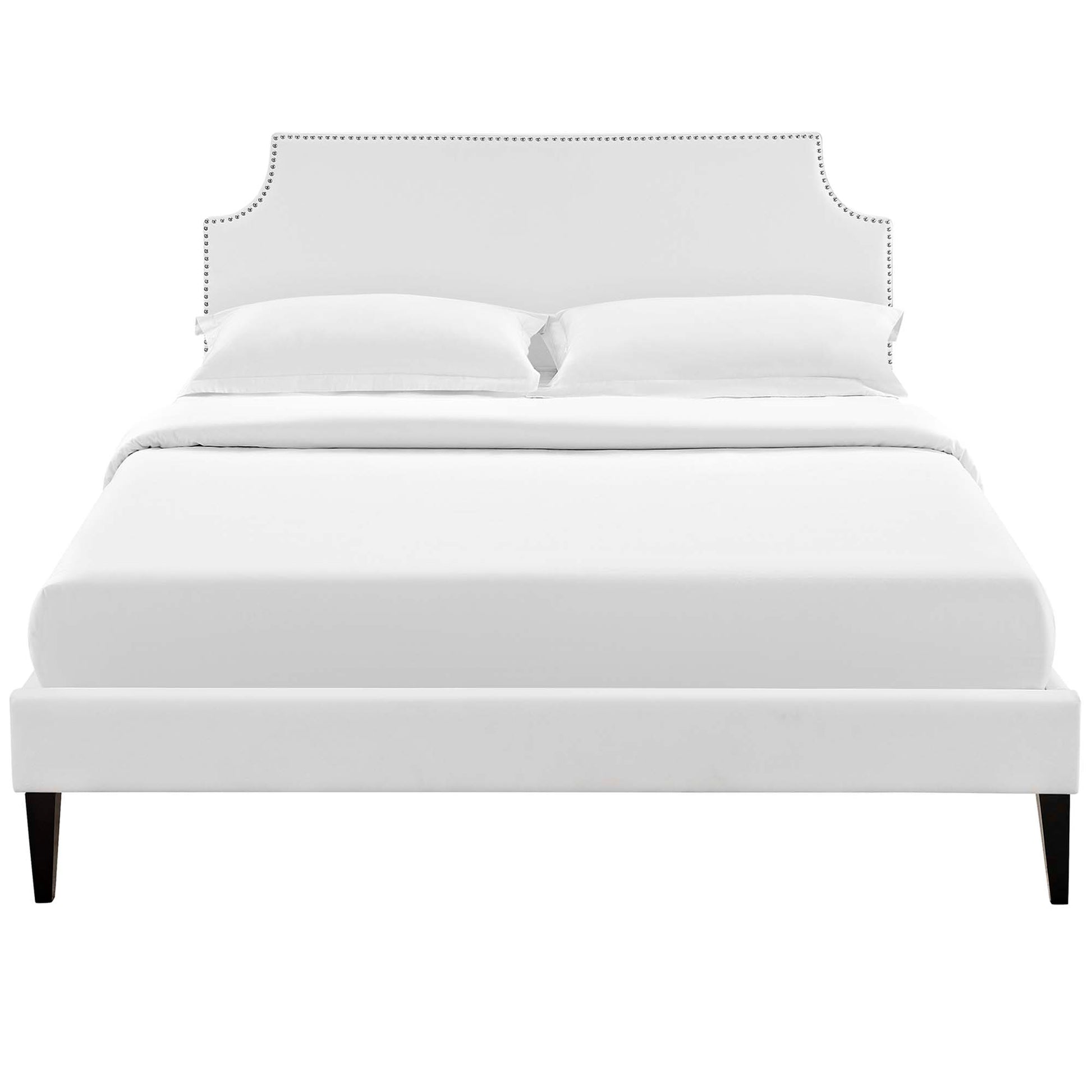 White upholstered bed with curved studded headboard, low footboard, and dark tapered legs.
