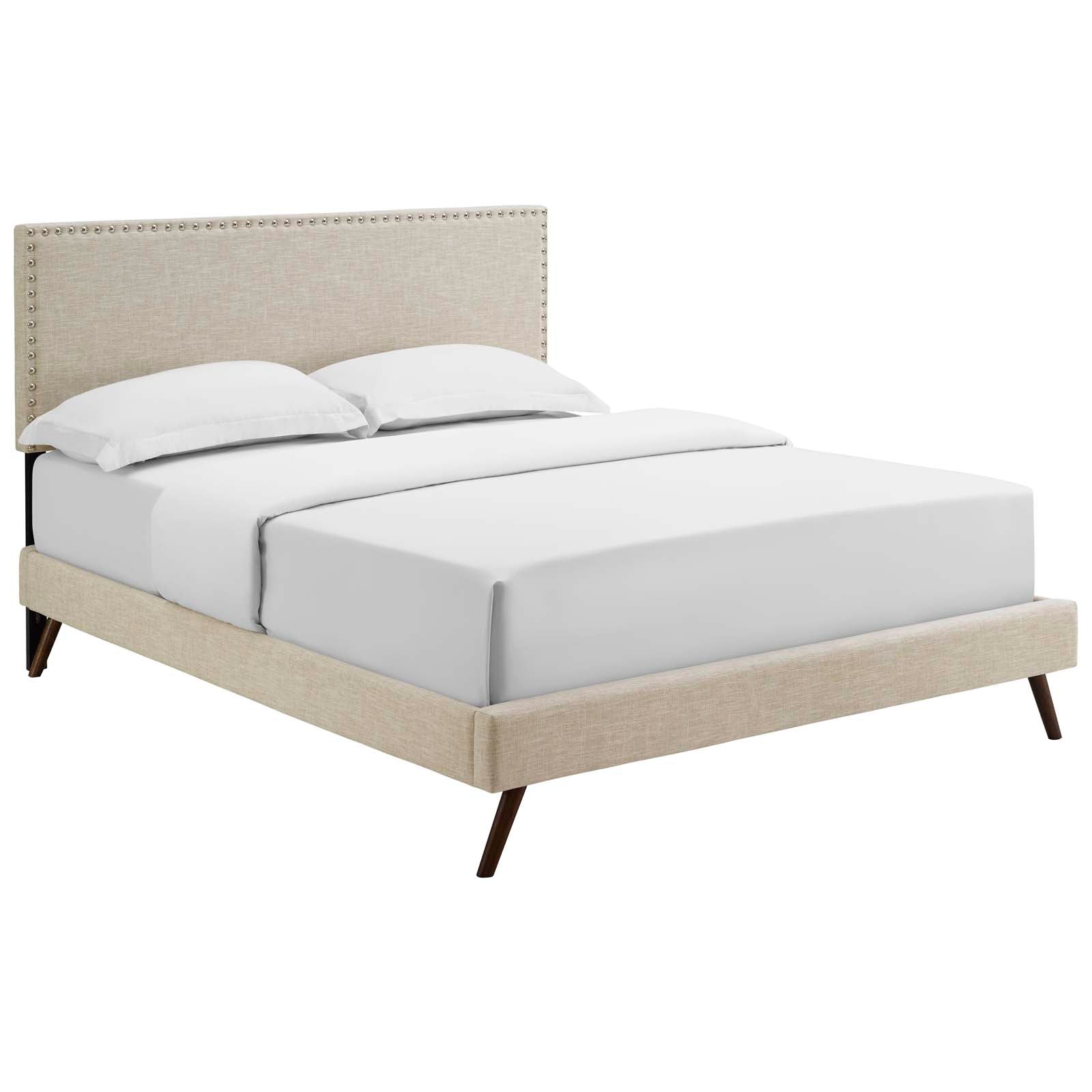 Beige fabric queen platform bed with round splayed legs and white bedding.