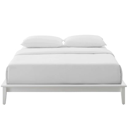 White full-size platform bed with a low-profile frame, white bedding & two plush pillows for a minimalist bedroom look.