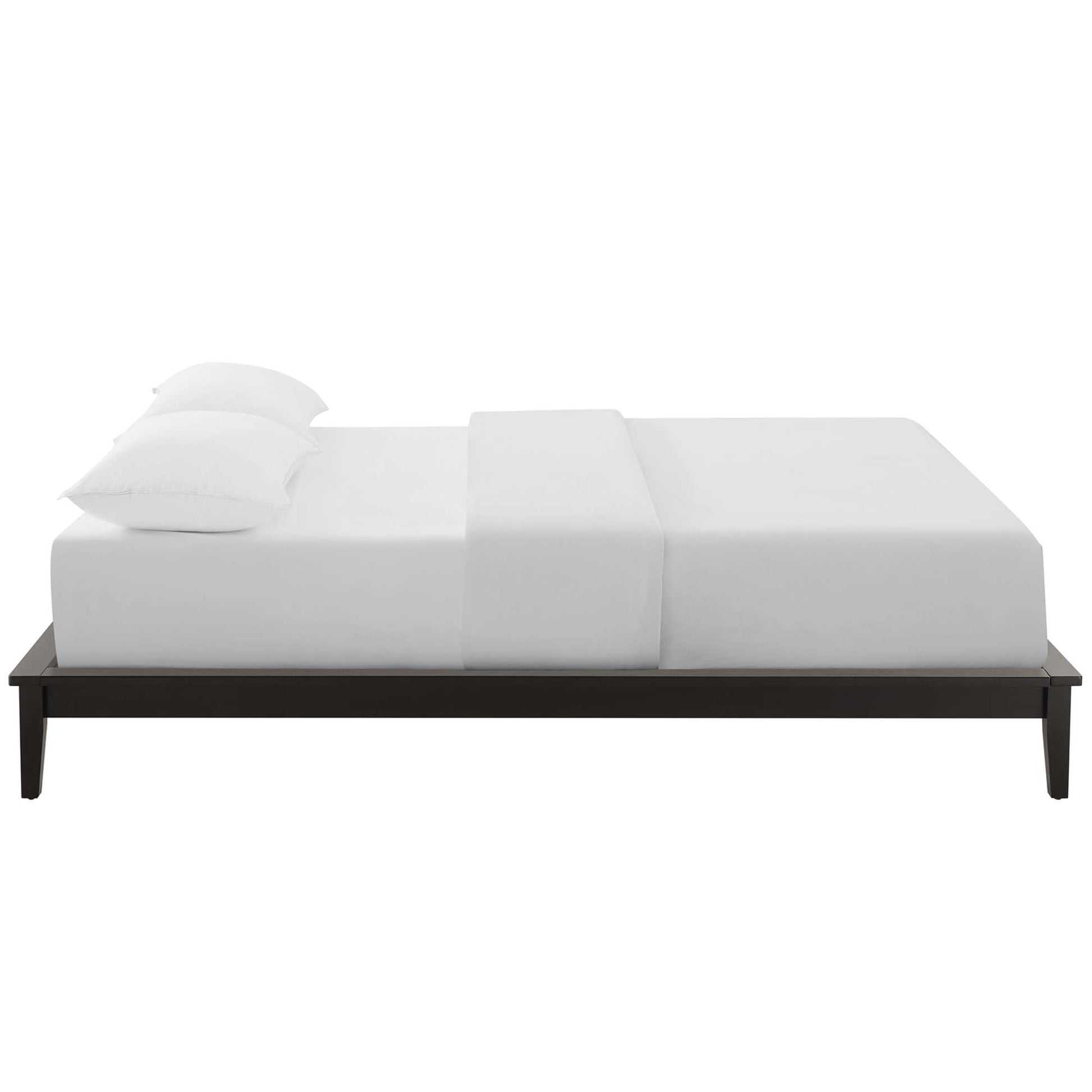 Low-profile dark wood platform bed with white bedding and two pillows, minimalist modern design.