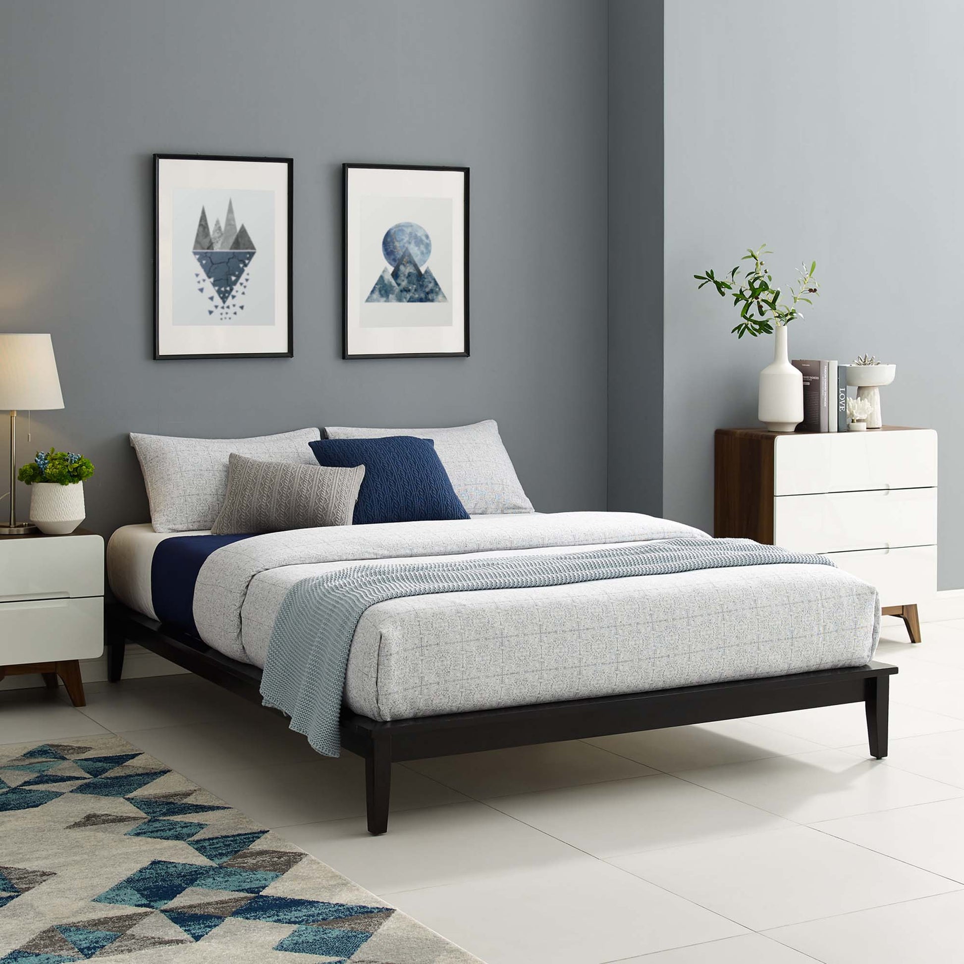 Modern queen platform bed frame with dark cappuccino wood finish, grey bedding and blue accents; grey walls, geometric art, white dresser, patterned rug.
