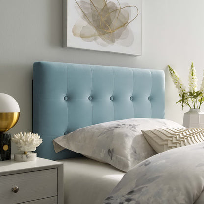 Light blue tufted upholstered headboard with button tufting, white-gray bedding, modern nightstand, and abstract wall art.