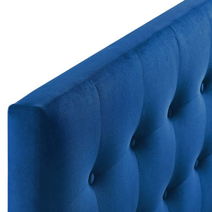 Blue velvet button-tufted headboard with vertical channels, close-up view.