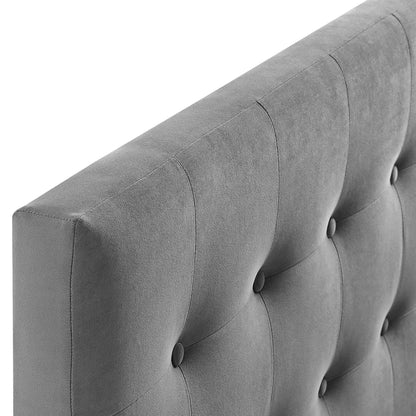 Close-up of gray tufted fabric upholstery with vertical channels & button tufting on a king headboard