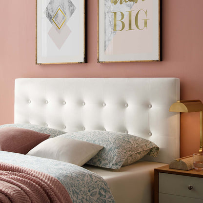 White tufted upholstered headboard with button details, pink walls, patterned bedding, blush pillows and gold bedside lamp.