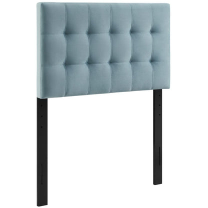 Light blue tufted fabric headboard with square panels, mounted on black metal posts.