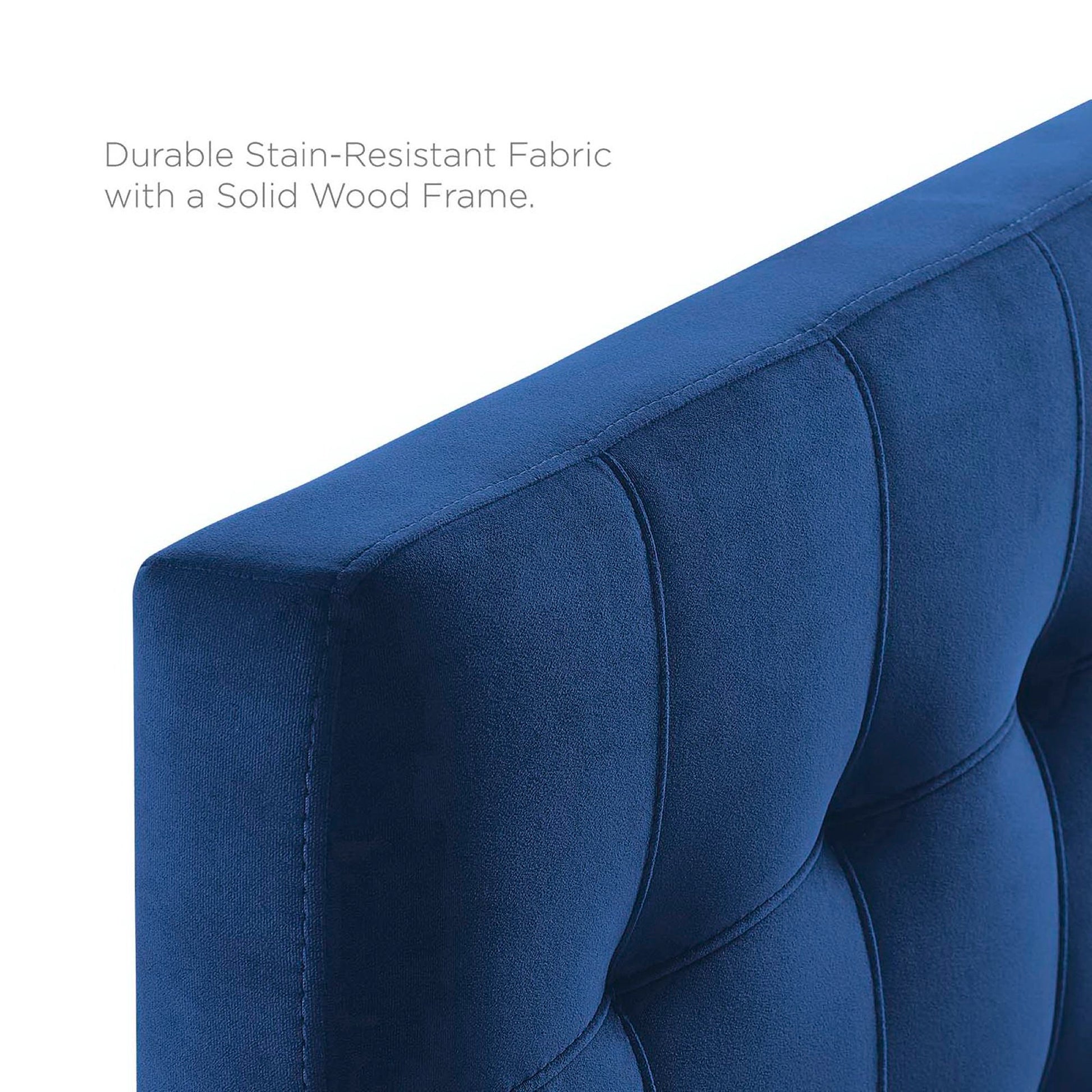 Blue tufted headboard close-up showing biscuit tufting and velvet upholstery.