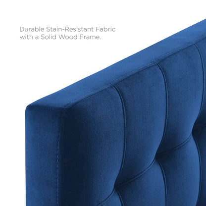 Blue tufted headboard close-up showing biscuit tufting and velvet upholstery.