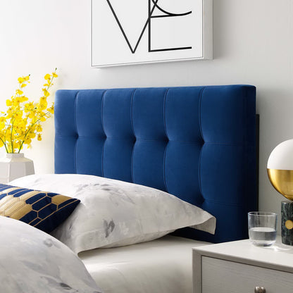 Navy blue tufted velvet twin headboard with white bedding.