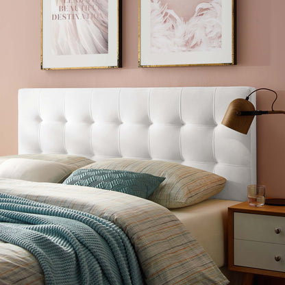 White tufted headboard with blush wall, striped bedding, blue knit throw, teal pillow, wooden nightstand and wall lamp.