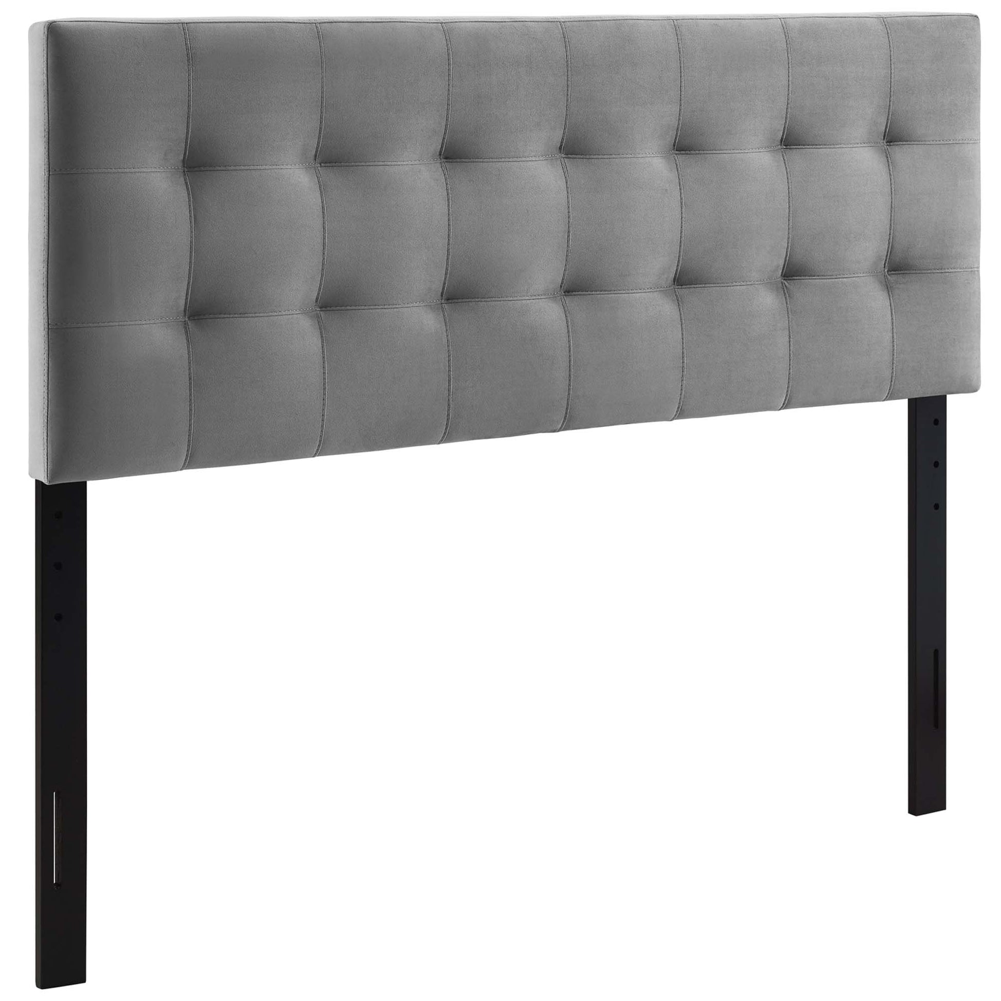 Gray biscuit-tufted fabric headboard with tufted panels, black metal legs, a modern bed centerpiece.