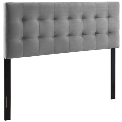 Gray biscuit-tufted fabric headboard with tufted panels, black metal legs, a modern bed centerpiece.