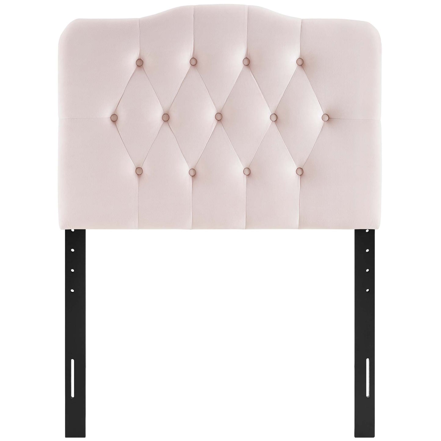 Blush pink velvet headboard with diamond button tufting on a curved top, supported by black metal legs.