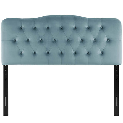 Blue velvet tufted headboard with diamond button pattern and curved top, supported by black metal legs.