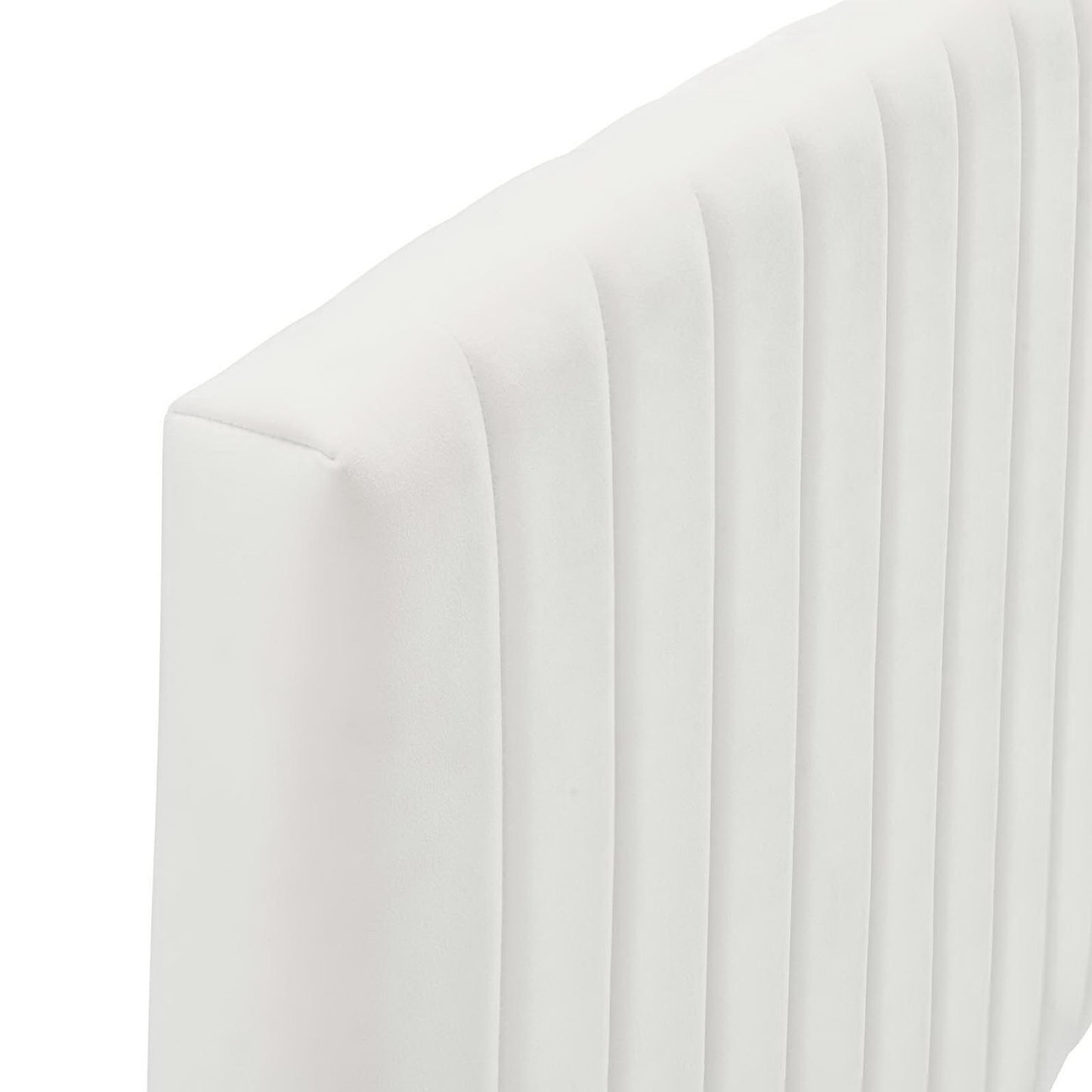 White curved-back upholstered twin headboard with vertical channel tufting.