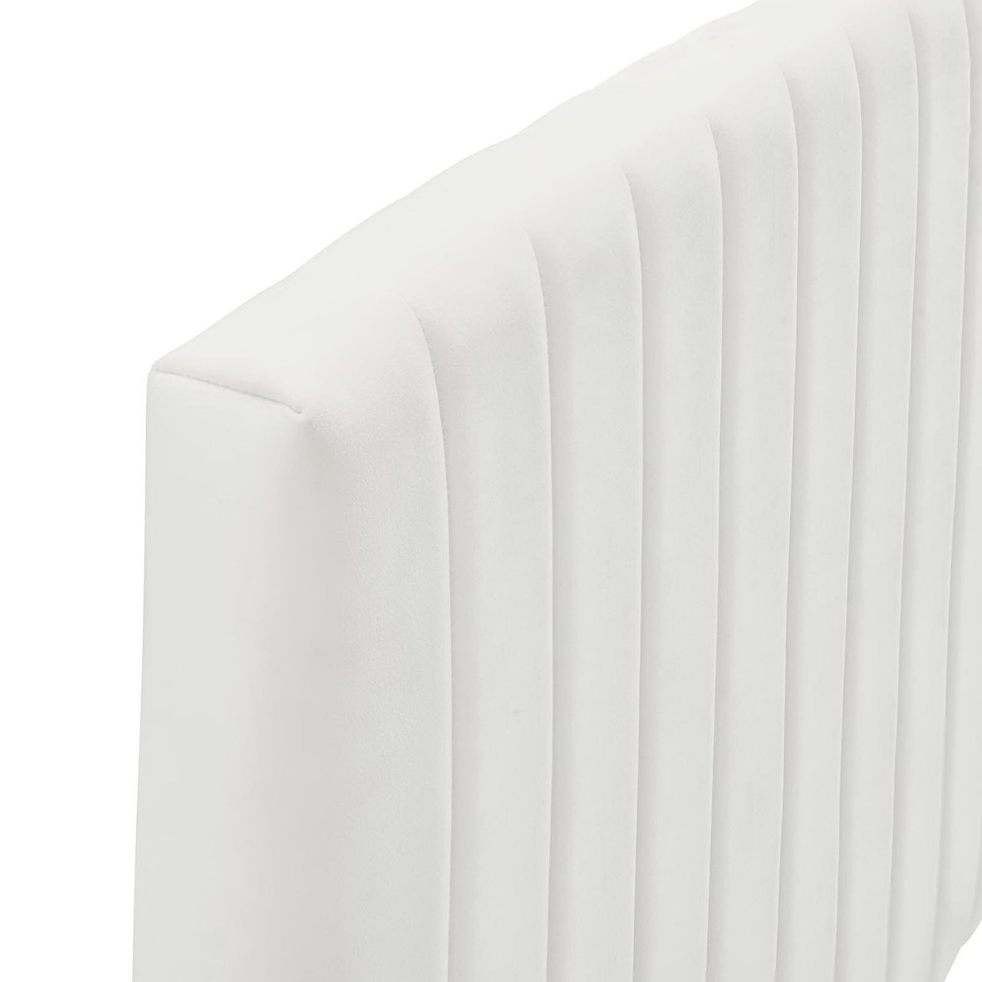 White curved-back upholstered twin headboard with vertical channel tufting.