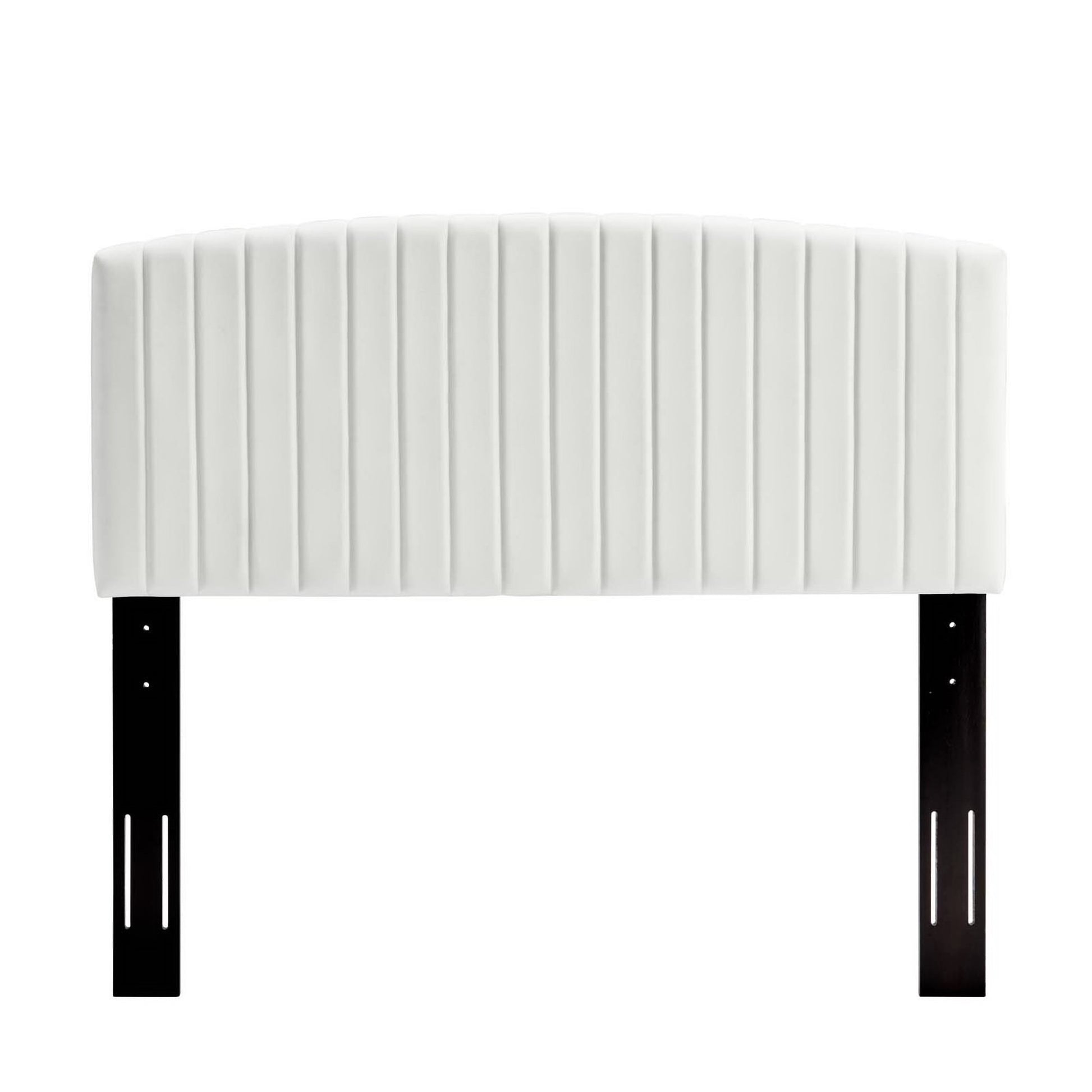 White quilted upholstered headboard with vertical channel tufting, supported by black metal legs.