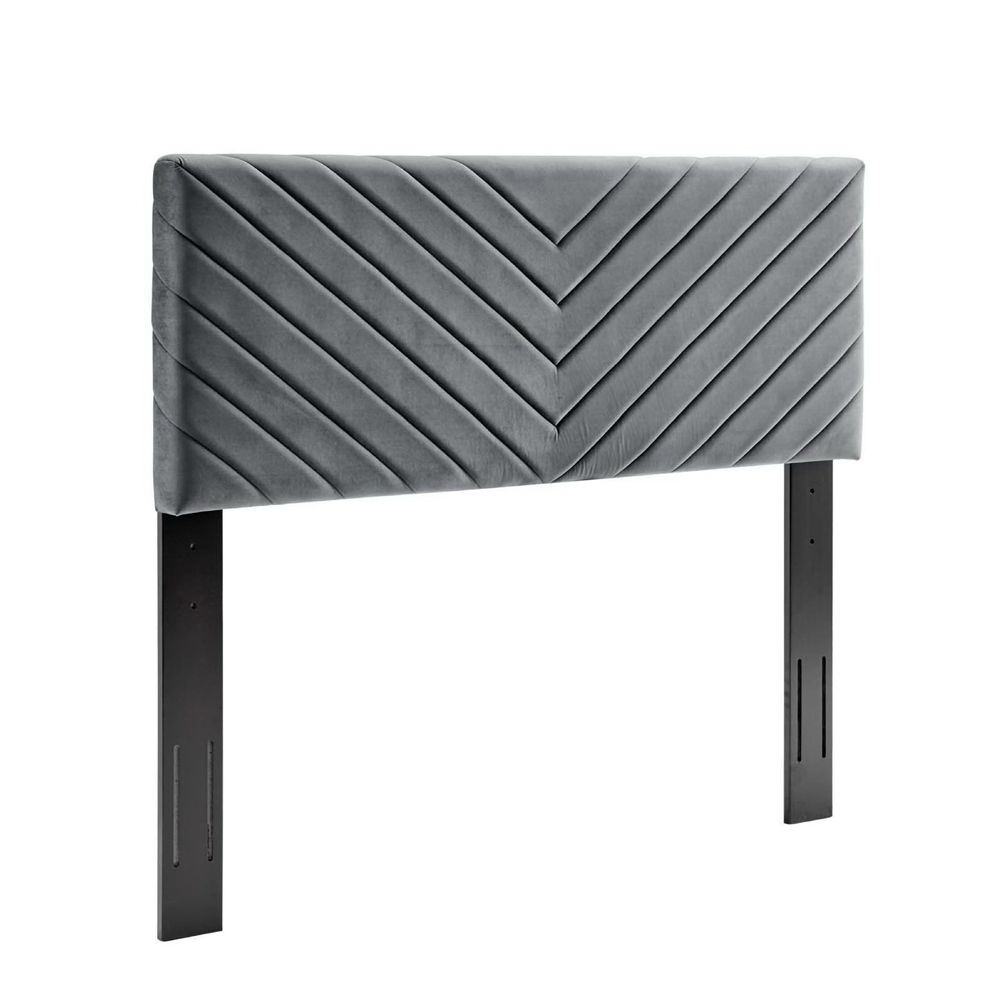 Grey velvet upholstered headboard with angular channel tufting, mounted on black metal legs.