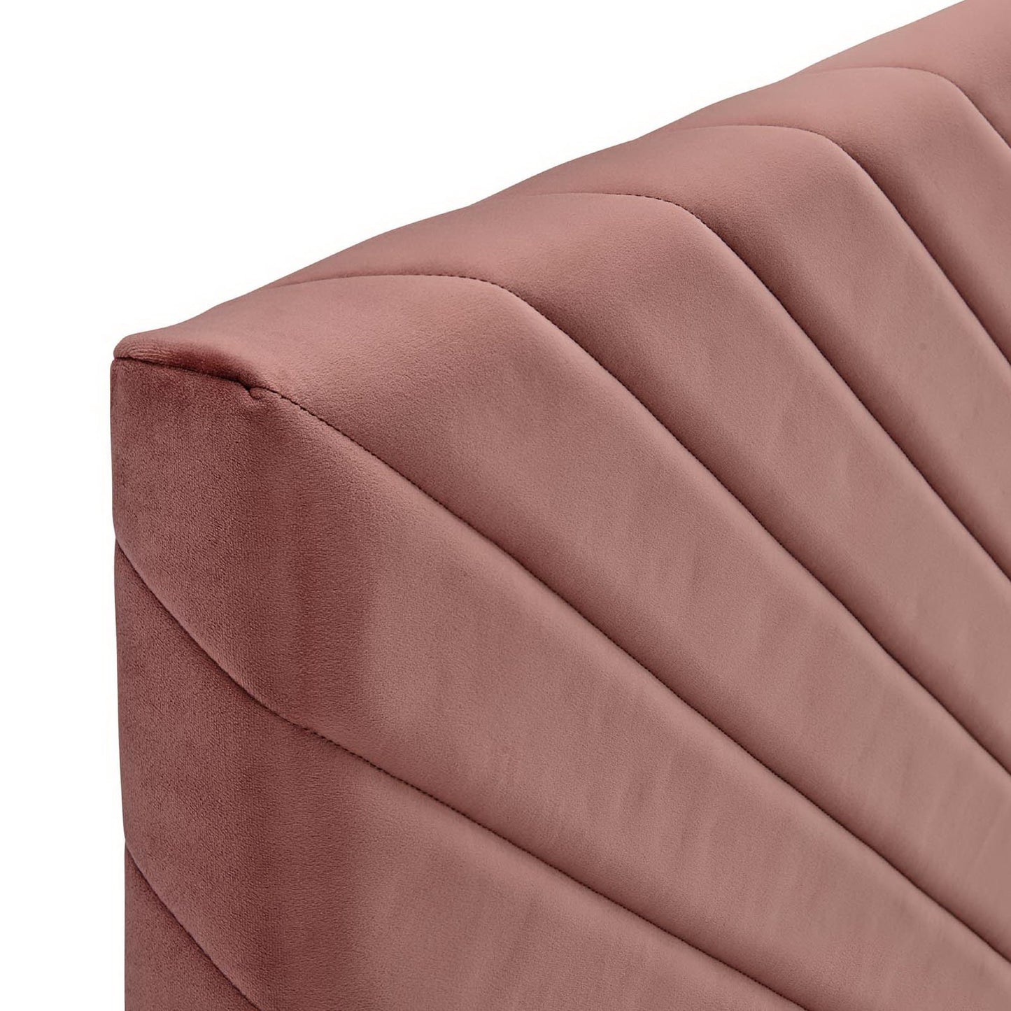 Dusty rose velvet headboard with angular channel tufting.