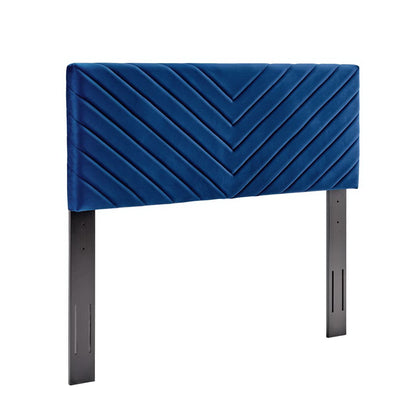 Navy blue velvet headboard with angular channel tufting, mounted on black metal legs.
