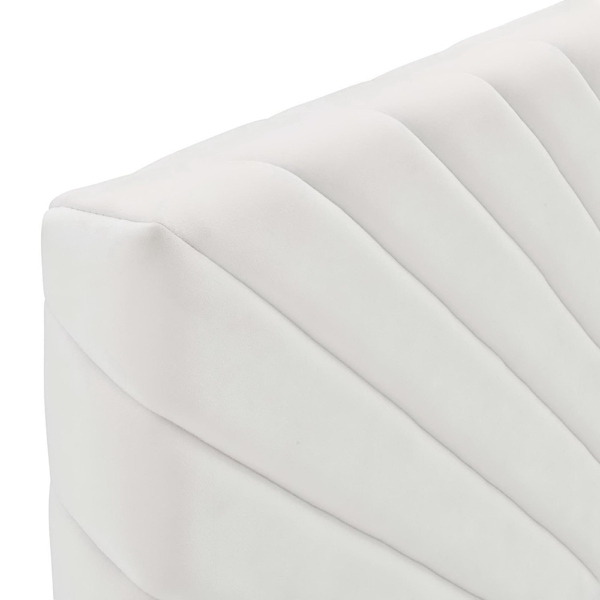 White velvet headboard with angular diagonal channel tufting.