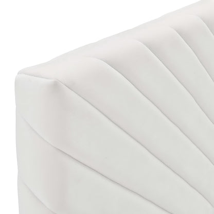 White velvet headboard with angular diagonal channel tufting.