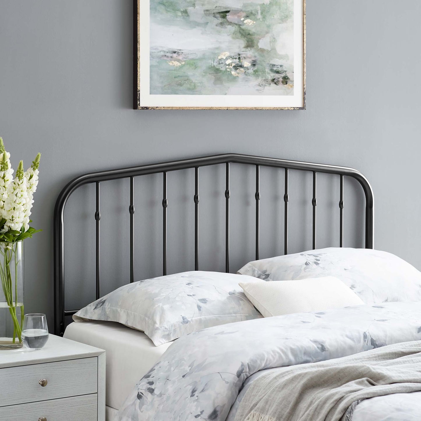 Black metal king headboard with an arched top and vertical rods.