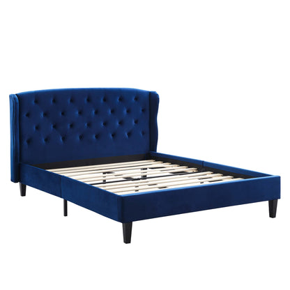 Navy blue velvet bed frame with a tall tufted headboard, low rails, slatted foundation, and black tapered legs.