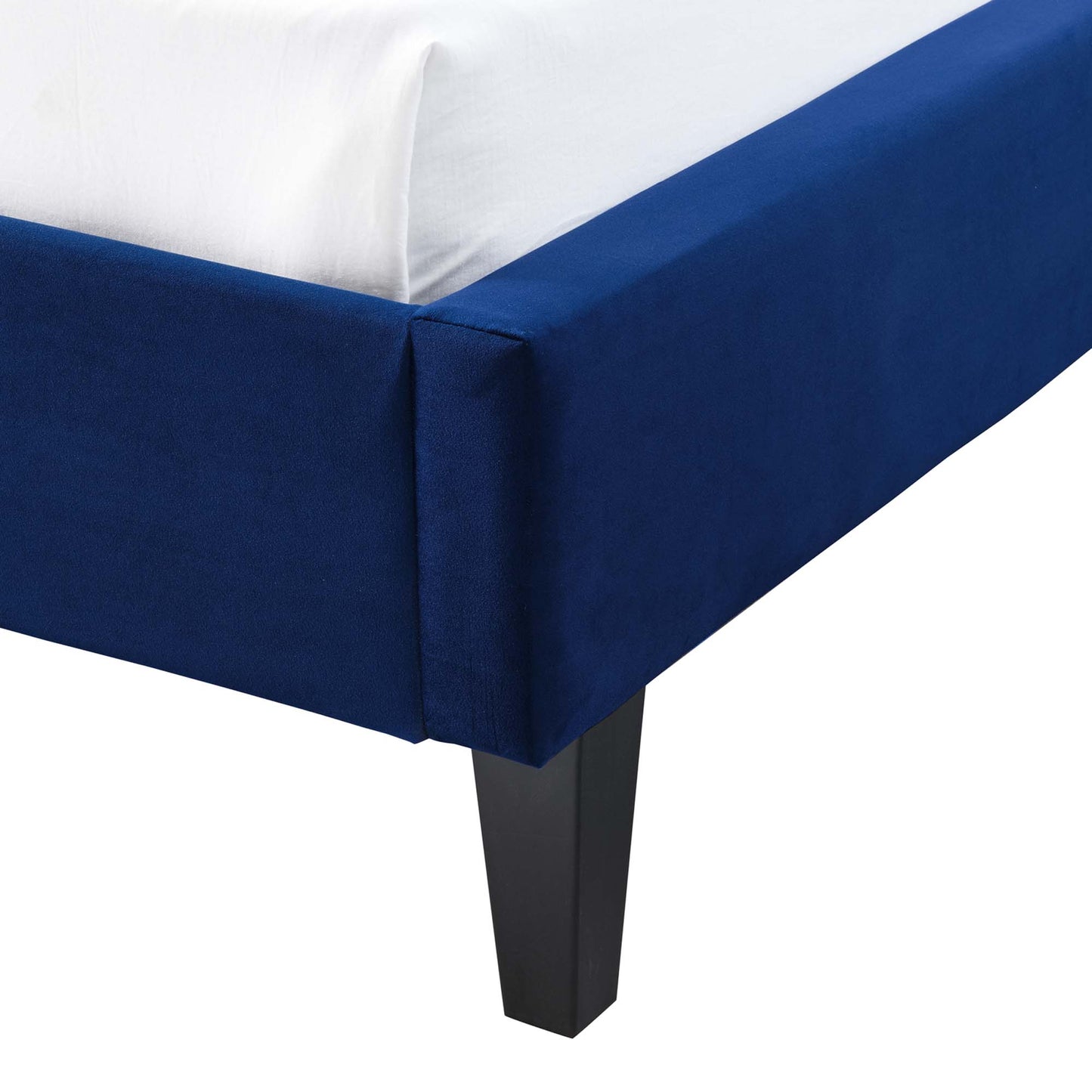 Navy blue upholstered platform bed with black tapered legs and a white mattress.