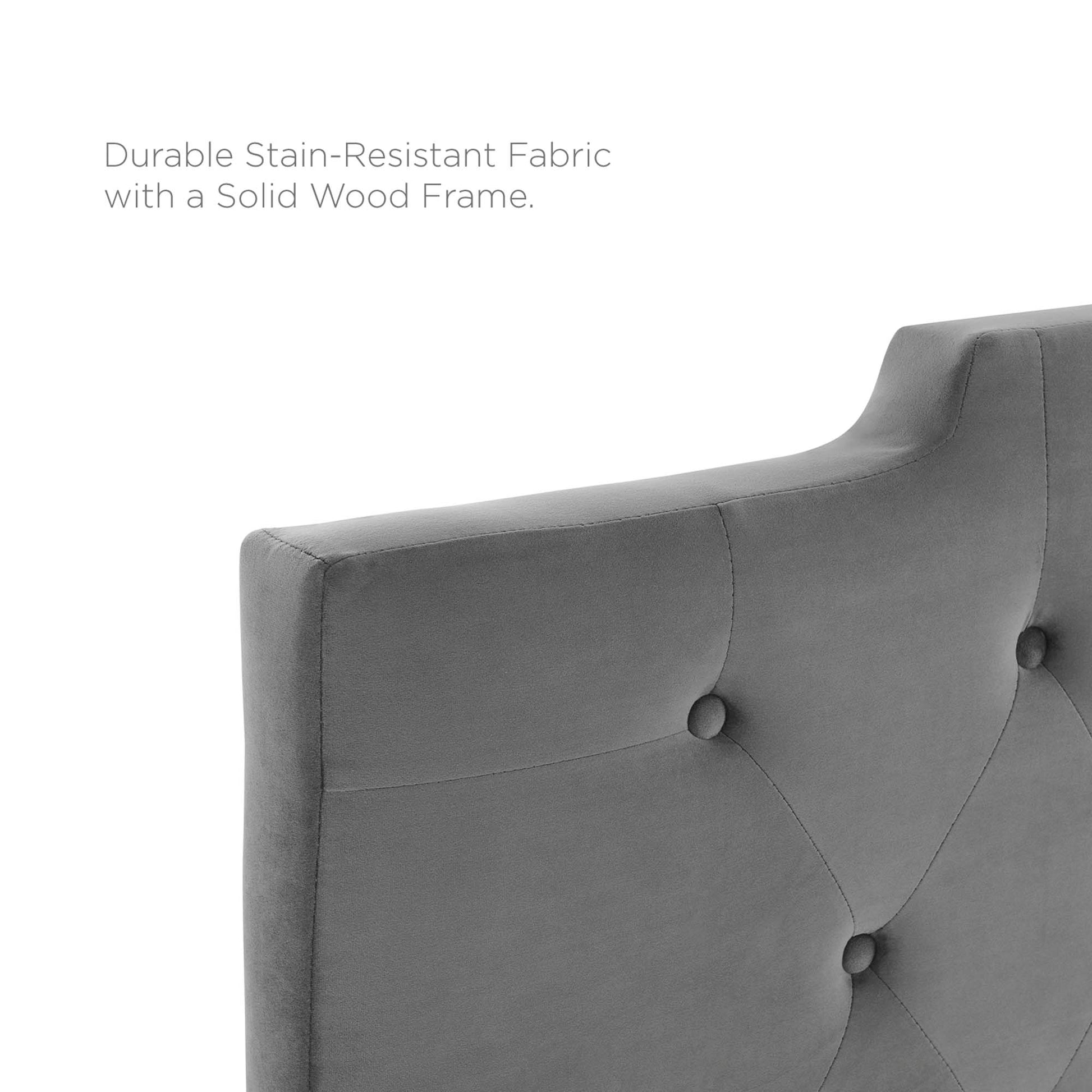 Gray tufted fabric upholstery with button accents and a curved backrest, supported by a solid wood frame.