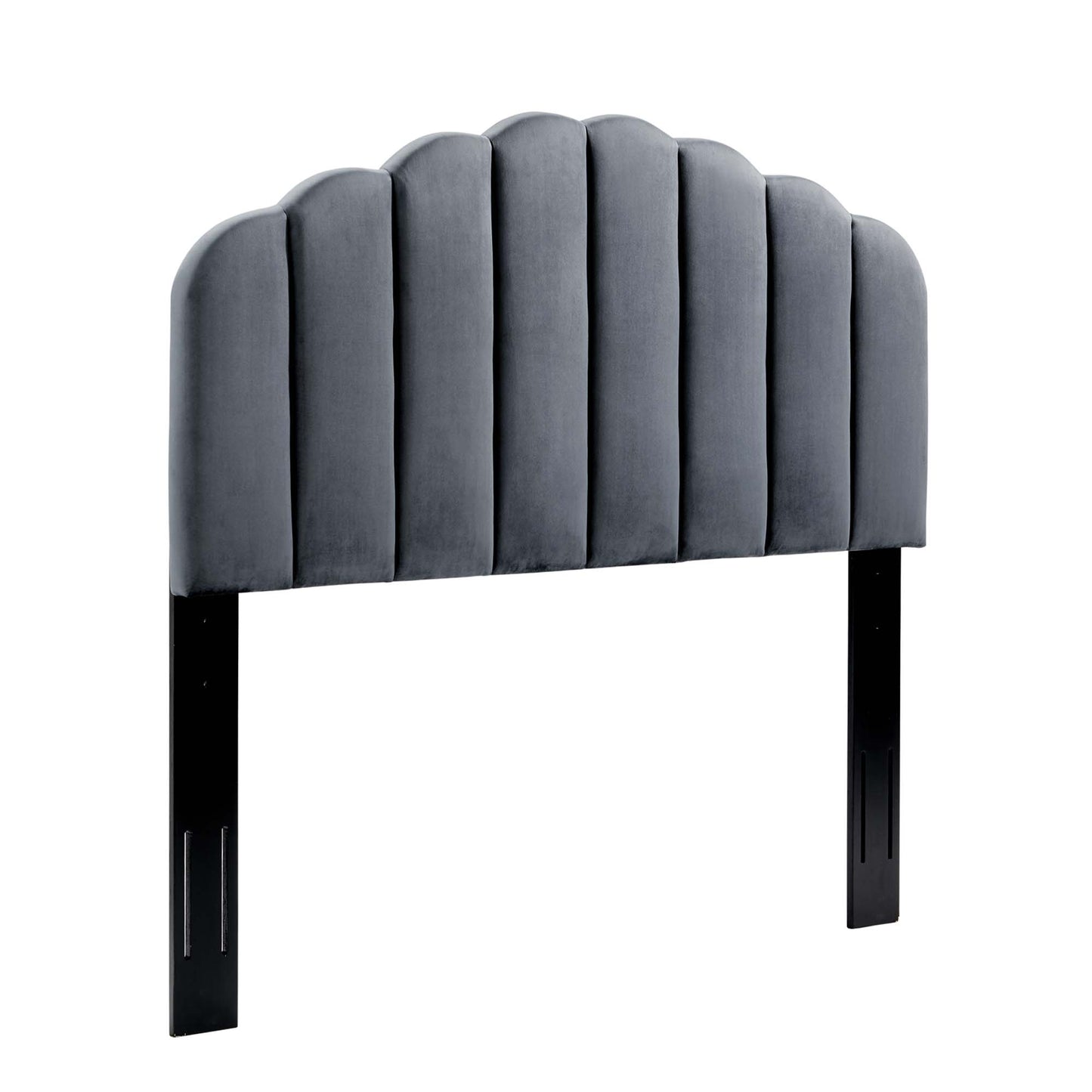 Gray velvet upholstered headboard with scalloped arched top and vertical channel tufting, supported by black legs.