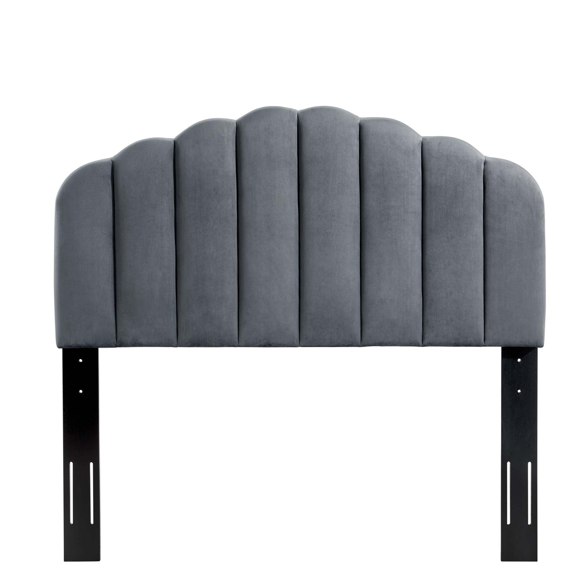 Grey velvet upholstered arched headboard with vertical channel seams, mounted on black metal brackets.