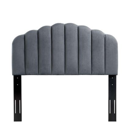 Grey velvet upholstered arched headboard with vertical channel seams, mounted on black metal brackets.