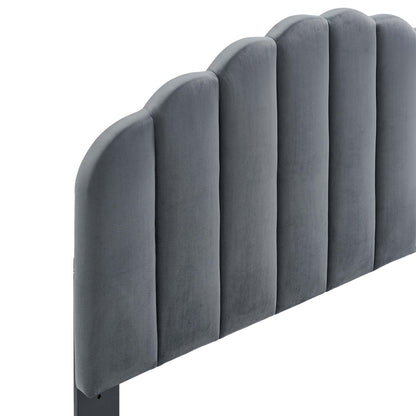 Gray velvet channel-tufted headboard with arched padded vertical panels.