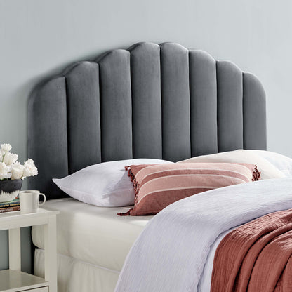Gray velvet scalloped headboard, white bedding, pink striped lumbar pillow, lavender throw, white nightstand with flowers